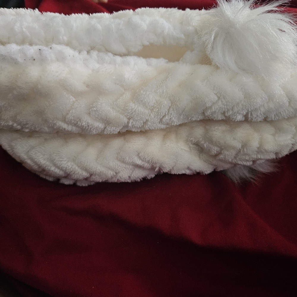 White Fuzzy Slippers with Pom Poms And Rubber Grips On The Bottom.